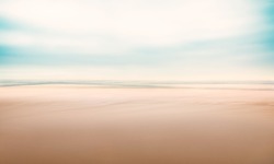 A minimalist, abstract seascape with panning motion combined with a long exposure.  Image displays a fine grain texture at 100 percent.