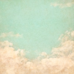 Sky, fog, and clouds on a textured, vintage paper background with grunge stains.