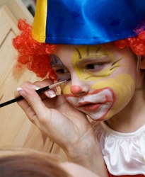 The boy wearing funny clown