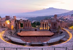 Sunset on the ancient roman-greek amphitheater with the Giardini Naxos bay in the back in Taormina, Sicily, Italy