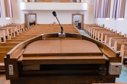 Pulpit at the a church with wooden pews