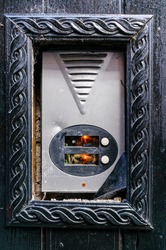 A broken call bell, allowing electronics inside to be seen.