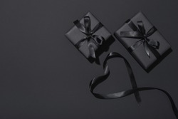 Black Friday sale flat lay with presents and ribbon in heart shape