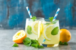 Lemonade or mojito cocktail with lemon and mint, cold refreshing drink or beverage with ice