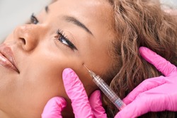 Lady receives botulinum toxin injections in a cosmetology clinic