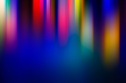 Abstract blurred background multicolored light rays elongated vertically. Background for design.