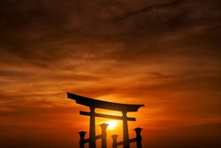 silhouette floating torii under cloudy sky at sunset, shinto shrine gate