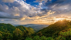 beautiful rainforest mountains landscape in cloudy day at sunset