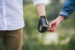 CloseUp Shot Of Man With a prosthetic limb Holding Hands With Female Partner, gentle touch, outdoor image