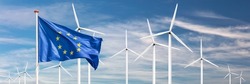Official flag of the European Union in front of a large windpark with wind turbines