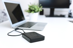 External backup disk hard drive connected to laptop
