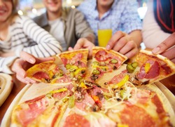 Image of teenage friends hands taking slices of pizza