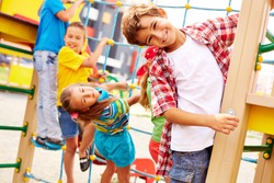 Image of joyful friends having fun on playground outdoors 
