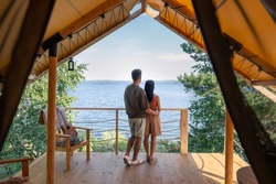 rear view of affectionate couple enjoying summer vacation in glamping house
