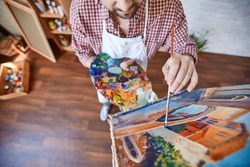 Male artist painting Venetian street