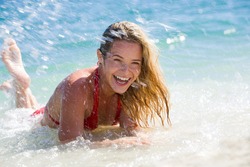 Photo of attractive woman lying in water and enjoying bathing in the sea