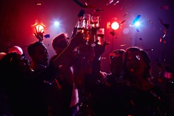 Young friendly people toasting in night club