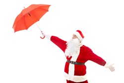 Photo of confused Santa Claus stretching arm with red umbrella in isolation