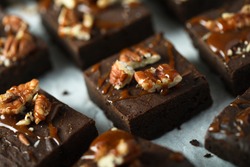 Traditional homemade brownies with salted caramel and pecan nuts