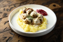 Traditional Swedish meatballs with potato and berry sauce
