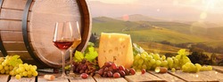 Fresh Grapes And Wine With Cheese On The Background Of An Italian Landscape. Tuscany Region
