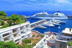 Luxury boats and large cruise ship inside the main harbor of Monaco 