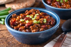 Delicious homemade beef chili con carne with green onion garnish.