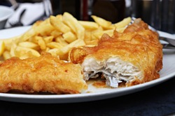 Fish and Chips on a white plate, shallow focus