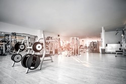 Equipment And Machines At The Empty Modern Gym Room. Fitness Center. Toned image.