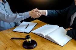 Lawyer or judge gavel with balance handshake with client or customer about agreement how to  use arbitration