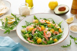 Shrimps salad with arugula, mango and avocado. Healthy food concept. Top view.