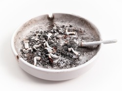 Dirty ashtray with cigarette butts and cigarette isolated against white background