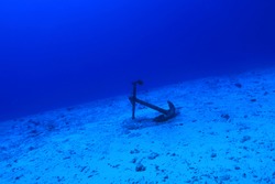Anchor of old ship underwater on the bottom of the ocean 