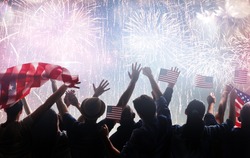 Patriotic holiday. Silhouettes of people holding the Flag of the USA. America celebrate 4th of July.