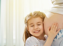 happy pregnant woman with her child