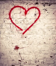 Red Love Heart hand drawn on brick wall grunge textured background trendy street style