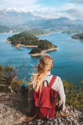Woman backpacker enjoying lake view alone outdoor Travel adventure in Turkey active vacations healthy lifestyle eco tourism girl sitting on cliff