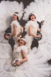 Attractive women in white art deco costumes
