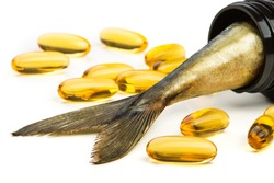 Fish oil capsules and fish tail in brown jar