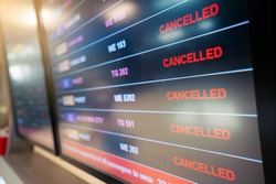 flights cancellation status on flights information board in airport because coronavirus or pandemic effected. flight cancellation, airline business crisis, airline bankrupt, tourism crisis concept
