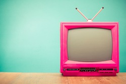 Retro old television from 80s front mint green wall background