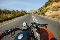 The Road view over the handlebars of motorcycle