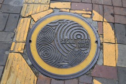 attractive sewer or manhole cover on street in Seoul, South Korea