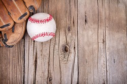 Baseball and mitt on rustic wooden background