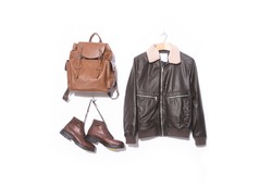 Men's brown leather jacket in the hanging and set of new fashion leather brown backpack with brown boots 


