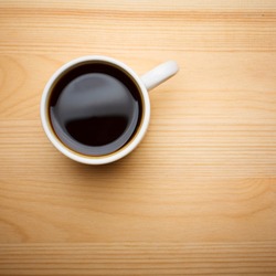 Cup of Coffee on Wooden Tabletop, Top View