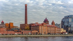 Old red brick building of former spinning-thread factory converted to business center on Vyborgskaya embankment. Saint-Petersburg, Russia.