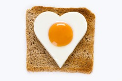 heart shaped cooked egg on a slice of toast