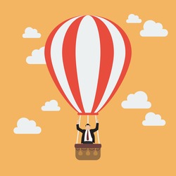 Businessman celebrating in hot air balloon