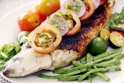 A grilled milk fish garnish with vegetables